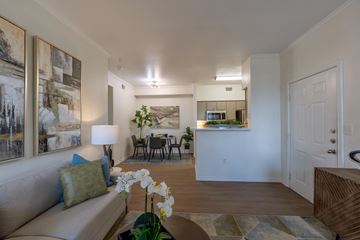 Lubbock apartment for rent - A living room with a couch, a table, and a painting on the wall.
