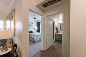Lubbock apartment for rent - A bedroom with a bed and a ceiling fan.