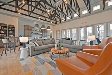 Temple apartment for rent - A living room with a grey couch and orange chairs.