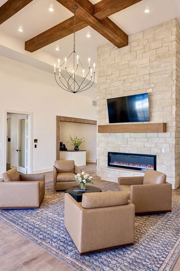 Lubbock apartment for rent - A living room with a fireplace and a television mounted above it.