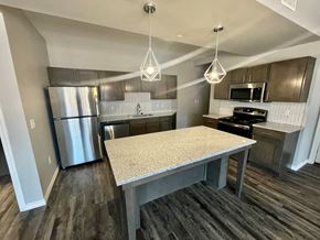 Lubbock apartment for rent - a kitchen with stainless steel appliances and a granite counter top