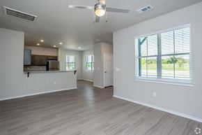Tyler apartment for rent - A spacious room with a ceiling fan and a window with blinds.