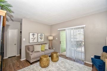 Wichita Falls apartment for rent - a living room with a couch and a door to a balcony