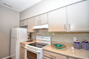 Wichita Falls apartment for rent - a kitchen with white appliances and white cabinets