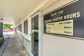 Irving apartment for rent - a sign on the side of a building that reads leasing center hours closed