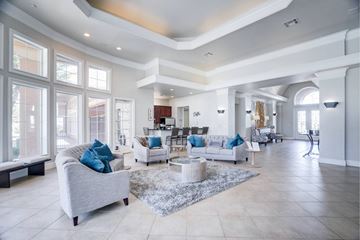 Lubbock apartment for rent - A spacious living room with a grey sofa and a white coffee table.