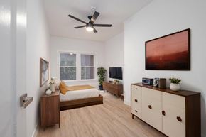 Los Angeles apartment for rent - A bedroom with a bed, dresser, and a ceiling fan at Westmore Manor Apartments, Los Angeles