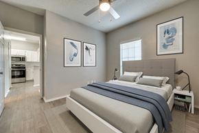 Irving apartment for rent - a bedroom with a bed and a ceiling fan at Foxborough Apartments, Irving, TX, Texas, 75061