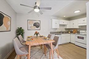 Las Vegas apartment for rent - A dining room with a table set for two and a plant in the corner.