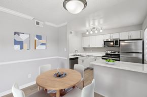 Phoenix apartment for rent - A kitchen with a table and chairs in the middle of the room.