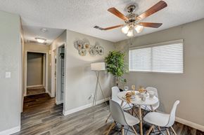 Laughlin apartment for rent - a dining room with a table and chairs and a ceiling fan at Desert Bay Apartments, Laughlin, NV