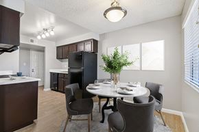 Phoenix apartment for rent - A dining room with a table set for two and a potted plant on the table.