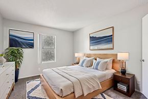 Las Vegas apartment for rent - A bedroom with a large bed and a painting on the wall.