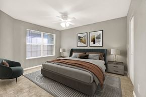 Orlando apartment for rent - A bedroom with a large bed and a chair.