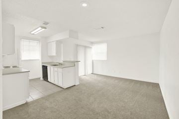 Orlando apartment for rent - A kitchen area with a white counter and a trash bin.