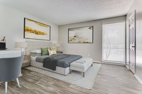 Richardson apartment for rent - a bedroom with a bed and a desk and a window at Falls on Clearwood Apartments, Richardson, TX, Texas