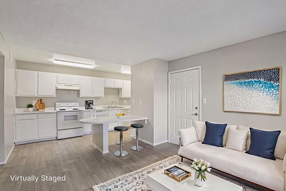 Las Vegas apartment for rent - A virtually staged living room with a white couch and a painting on the wall.