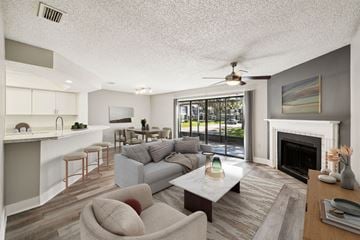 Orlando townhouse for rent - A living room with a grey couch and a fireplace.