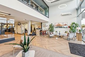 Kent apartment for rent - A modern office space with wooden floors and a variety of seating options.