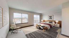 Kent apartment for rent - A bedroom with a bed, nightstand, and chair.