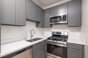 Los Angeles apartment for rent - A kitchen with a stove, sink, and microwave at Westmore Manor Apartments, California