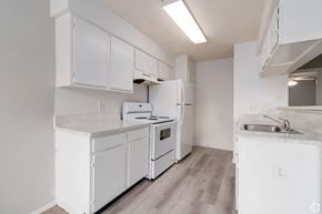Orlando apartment for rent - a white kitchen with white appliances and white cabinets at Village Lakes, Orlando, FL, 32808