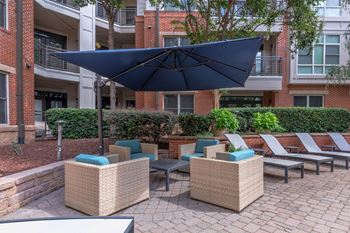Two courtyard seating areas with televisions