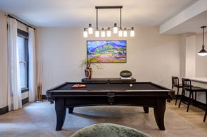 Raleigh apartment for rent - A  room with a pool table and a TV on the wall.