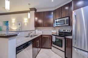 Raleigh apartment for rent - A kitchen with a stove top oven and a refrigerator.