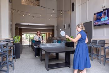 Two courtyard seating areas with televisions
