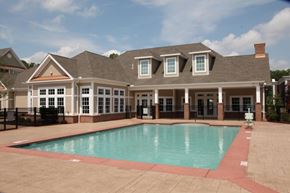 South Windsor apartment for rent - a swimming pool in front of a large house with a roof