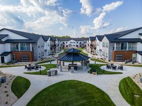 Janesville apartment for rent - A gazebo is surrounded by a grassy area in the middle of a housing development.