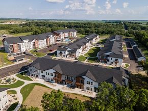 Janesville apartment for rent - A bird's eye view of a large, well-maintained apartment complex with multiple buildings and green lawns.