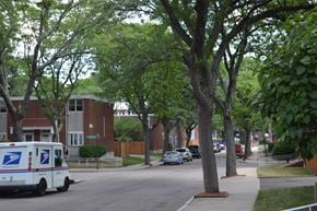 Roxbury townhouse for rent - A USPS mail truck is parked on a residential street.