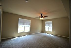 River Falls townhouse for rent - A room with a ceiling fan and two windows.