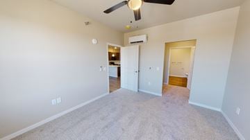 La Crosse apartment for rent - a spacious living room with carpet and a ceiling fan