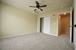 River Falls townhouse for rent - A room with a ceiling fan and carpeted floor.