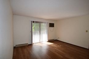 La Crosse apartment for rent - A room with wooden floors and white walls.