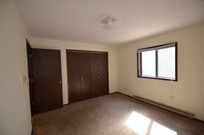 La Crosse apartment for rent - A room with a window and two brown doors.