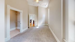 La Crosse apartment for rent - a living room with a carpeted floor and a door to a closet