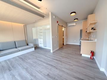 La Crosse apartment for rent - A living room with a grey sofa and a grey floor.