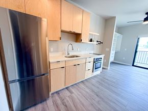 La Crosse apartment for rent - A modern kitchen with wooden cabinets and a stainless steel refrigerator.