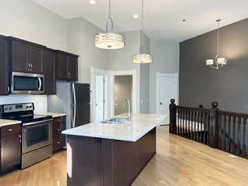La Crosse apartment for rent - a kitchen with stainless steel appliances and a marble counter top