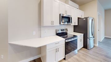 New Richmond apartment for rent - A kitchen with white cabinets and stainless steel appliances.