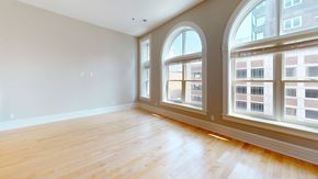 La Crosse apartment for rent - an empty living room with large windows and wood floors