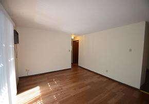 La Crosse apartment for rent - A room with wooden flooring and a door in the background.