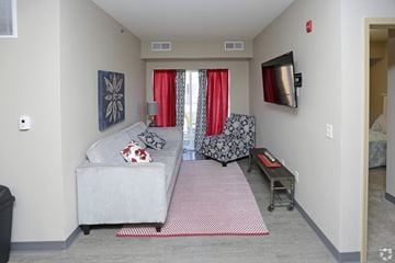 La Crosse apartment for rent - a living room with a couch and a chair and a television