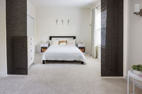 Arlington apartment for rent - A bedroom with a large bed and a dresser.