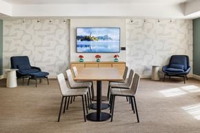 Arlington apartment for rent - A conference room with a large screen and chairs.