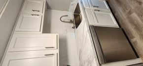Cincinnati apartment for rent - a small bathroom with white cabinets and a mirror